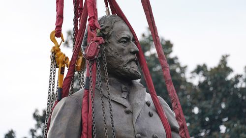 Lifting straps surrounded the statue of Confederate General Robert E. Lee as crews removed it. 