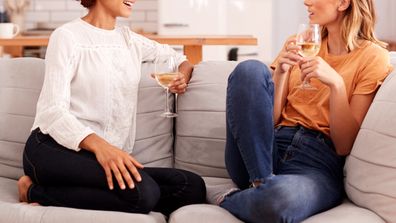 Two female friends drinking wine