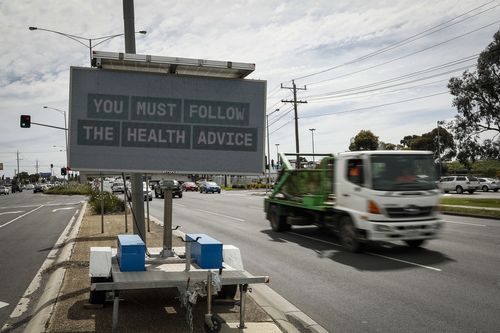 MELBOURNE, AUSTRALIA - OCTOBER 09: Traffic signs display COVID information on Sydney Road in Faulkner on October 09, 2021 in Melbourne, Australia.  Victoria has recorded 1,965 new COVID-19 cases and five deaths in the last 24 hours. It is the highest daily case figure recorded so far. Lockdown restrictions remain in place across metropolitan Melbourne and regional Victoria as new COVID-19 cases continue to emerge across the state. The state government is urging all Victorians to access the COVID