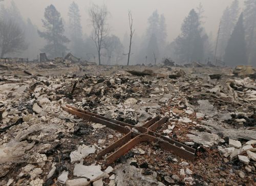 A cross is among the rubble of the Our Savior Lutheran Church in Paradise. 