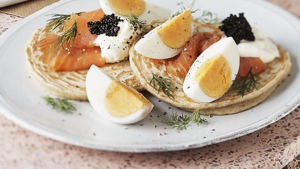 Blinis with hard boiled egg and smoked salmon