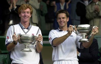 Mark Woodforde and Todd Woodbridge of Australia with the trophy after beating Paul Haarhuis of Holland and Sandon Stolle of Australia during the final of the mens doubles in the Wimbledon Lawn Tennis Championship at the All England Lawn Tennis and Croquet Club, Wimbledon, London. Mandatory Credit: Clive Brunskill/ALLSPORT