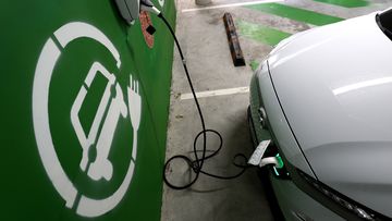 A Hyundai Kona Electric charges at a EV charge station