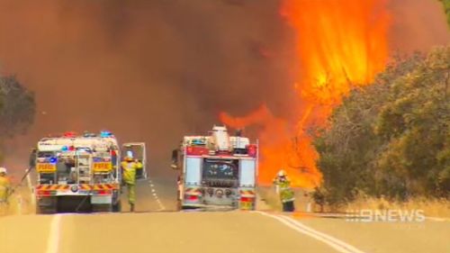 Fire crews battle the wall of flames. (9NEWS)
