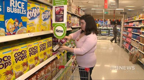 Part of Ms Dalliston's role is to 'face up' products in the store to make them appear neater on the shelf. (9NEWS)