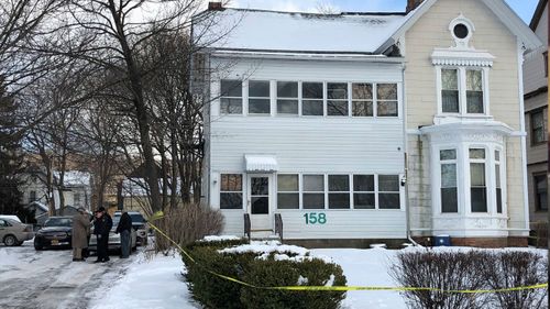 Police secure the perimeter of a home in Troy, N.Y., Tuesday, Dec. 26, 2017, after four bodies were discovered in a basement apartment. Troy police say the deaths are being treated as suspicious. (Nicholas Buonanno/The Record via AP)