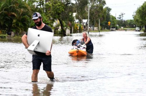 Residents wade through water 