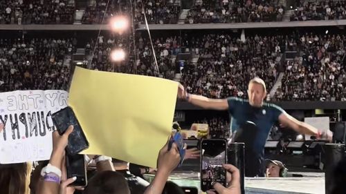 Chris Martin falls through a hole on the stage during Coldplay concert