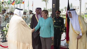 German Chancellor Angela Merkel (C) welcomed by Saudi Arabia's King Salman bin Abdulaziz Al Saud (R) before their official talks in Riyadh, Saudi Arabia 
