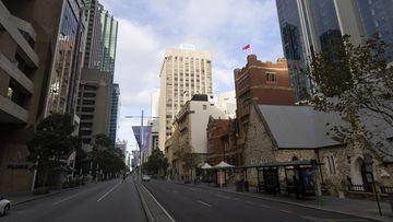 PERTH, AUSTRALIA - JUNE 29: Cars drive along an empty street in Perth CBD on June 29, 2021 in Perth, Australia. Lockdown restrictions have come into effect across the Perth and Peel regions for the next four days, following the confirmation of new community COVID-19 cases linked to the highly contagious Delta variant of the coronavirus. From midnight, residents in the Perth and Peel regions are only permitted to leave their homes for essential reasons, including purchasing essential goods, recei