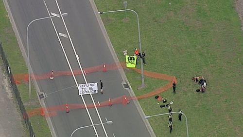 The advocates are carrying banners which read “SOS Manus”. (9NEWS)