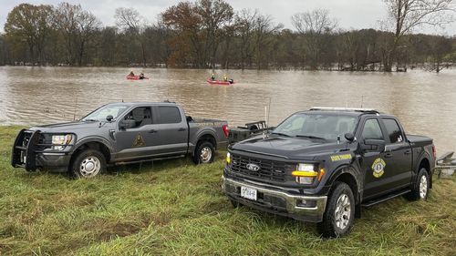 Patrol vehicles and lifeboats are from the rescue effort on the swollen river in Manes, Missouri.