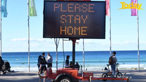 SYDNEY, AUSTRALIA - JULY 24: A digital warning sign asking people to stay at home in the suburb of Manly on July 24, 2021 in Sydney, Australia. New South Wales Premier Gladys Berejiklian declared a state of emergency as the state continues to report new community cases of the highly infectious Covid-19 delta variant. New South Wales is in the fourth week of a five-week lockdown and with cases on the rise, the lockdown is likely to be extended. (Photo by James D. Morgan/Getty Images)