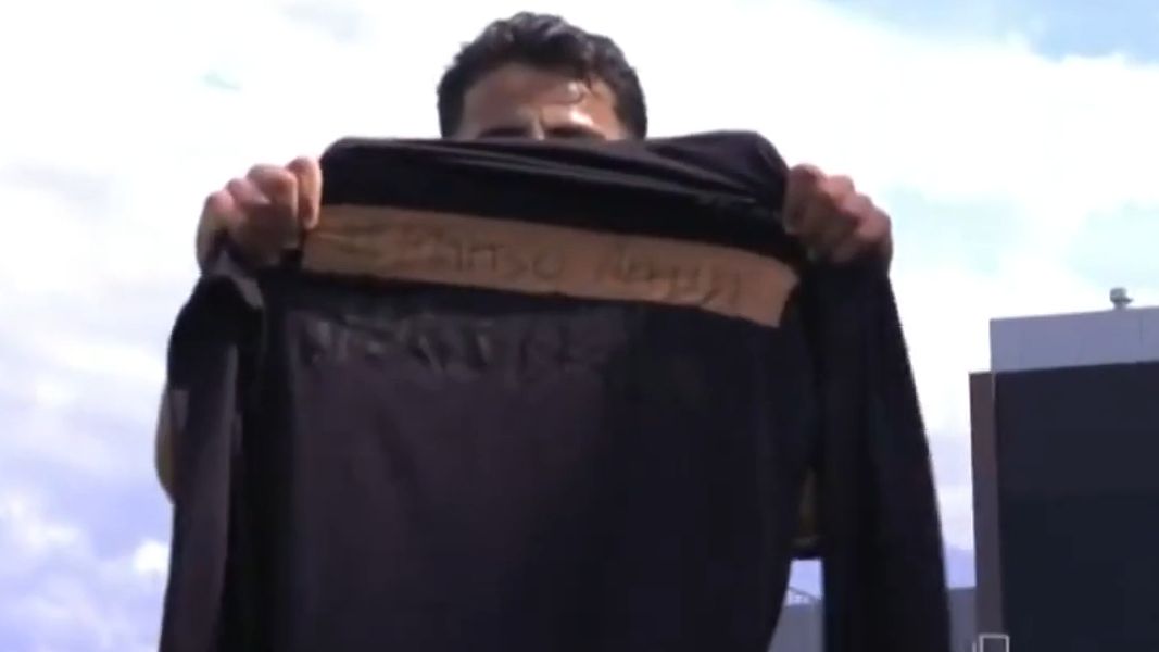 Daniel Arzani holds a shirt with Mahsa Amini&#x27;s name on it to support Iranian women&#x27;s rights.