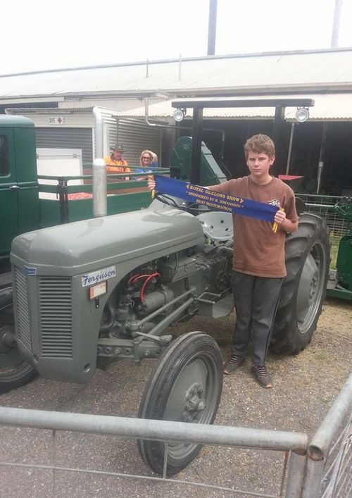 Sam with a prize-winning restored tractor on the farm. (Facebook)