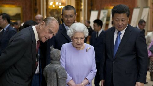 The Duke of Edinburgh, Queen Elizabeth II and Chinese President Xi Jinping view a display of Chinese items from the Royal Collection.