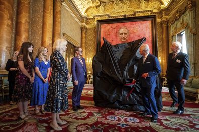King Charles III and Queen Camilla at the unveiling of artist Jonathan Yeo's portrait of the King, in the blue drawing room at Buckingham Palace, in London, Tuesday May 14, 2024.  