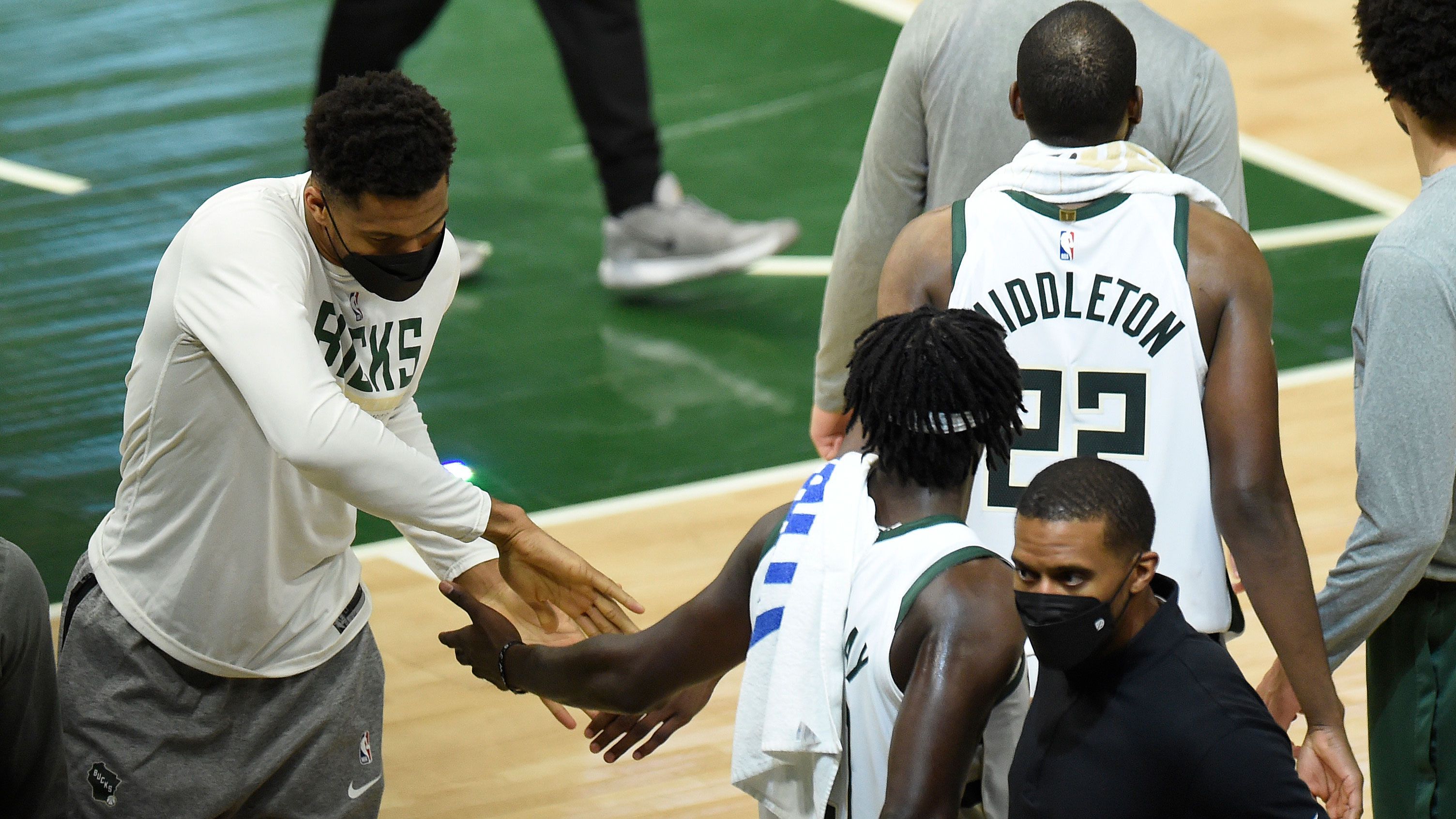 The injured Giannis Antetokounmpo supports his Bucks teammates.