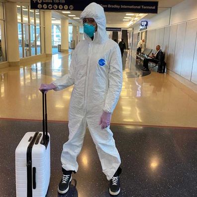 Naomi Campbell wears full hazmat jumpsuit to airport.