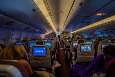 Bangkok, Thailand - July 9, 2023, on a Thai Airways plane, a calm and relaxing atmosphere, with every seat occupied, promoting a soothing and sleepy environment during the flight.