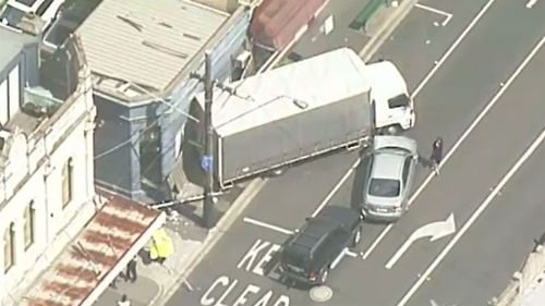 The six-tonne delivery vehicle did not make a stop until it crashed into a shopfront. (9NEWS)