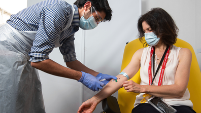 In this undated photo issued by the University of Oxford, a volunteer is administered the coronavirus vaccine developed by AstraZeneca and Oxford University, in Oxford, England. (University of Oxford/John Cairns via AP