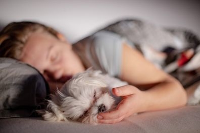 Woman and her dog sleeping.