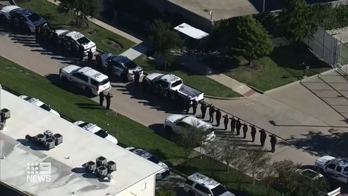 US police officers form a line in tribute to the officers in the aftermath of the shooting.