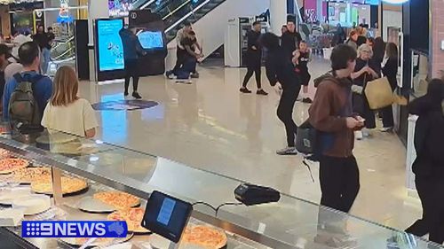 Shoppers and staff have recalled the moment they felt they were running for their lives as a wild brawl erupted between gangs with machetes inside a Melbourne shopping centre.Four youths have been arrested over the violent attack, with two already out on bail.
