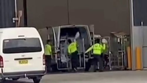Australia Post is investigating after workers were filming casually throwing parcels into a delivery van.