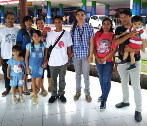 Aldi Novel Aldilang, 19, fourth from right, with his family after he returned to Indonesia. 