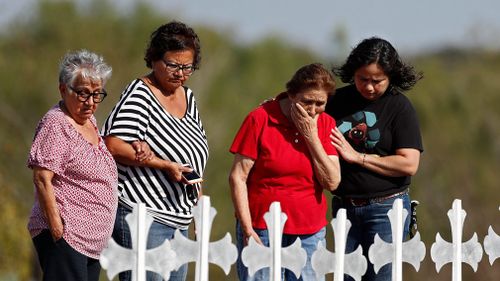 Mourners visit the 26 victims representing victims of the Sutherland Springs shooting. (AAP)