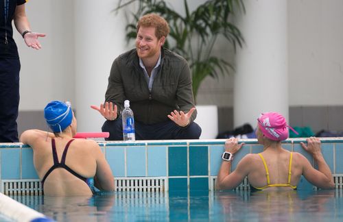 Prince Harry speaks to members of the Australian Invictus swimming squad during a visit to the Aquatic Centre at the Olympic Park Sports Centre in Sydney. (AAP)