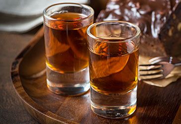 Which spirit is produced by distilling sugarcane molasses?