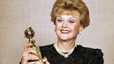 FILE - Angela Lansbury displays her Golden Globe Award for best actress in a television drama series for "Murder She Wrote" at the 47th Annual Golden Globe Awards on Jan. 21, 1990, in Beverly Hills, Calif. Lansbury, the big-eyed, scene-stealing British actress who kicked up her heels in the Broadway musicals Mame and Gypsy and solved endless murders as crime novelist Jessica Fletcher in the long-running TV series Murder, She Wrote, died peacefully at her home in Los Angeles on Tuesday. She was 9