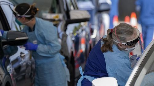 Staff collect samples at a drive-through COVID-19 testing clinic at Bondi Beach.