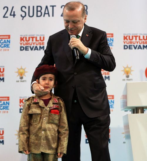 Erdogan brought the girl on stage to be paraded in front of crowds. (AAP)