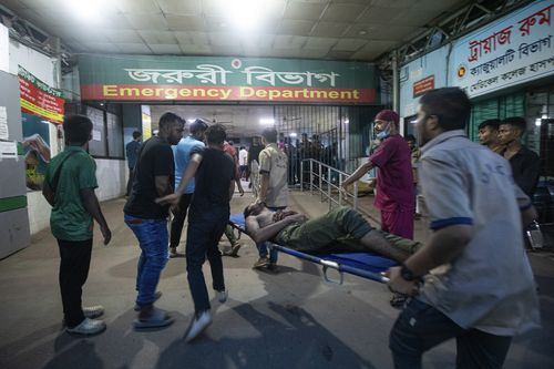 People use a stretcher trolley to carry a man, who was injured during the anti-government protests in Bangladesh, to the emergency ward of a hospital in Dhaka, Bangladesh, Sunday, Aug. 4, 2024.