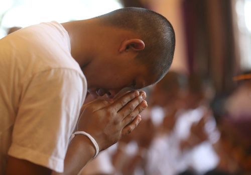 The boys and their coach also held a Buddhist prayer outside the cave they were trapped in before they returned to their normal lives. Picture: AAP