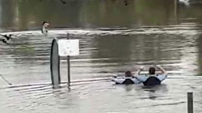 NSW Police rescue man from ute stuck in floodwaters.