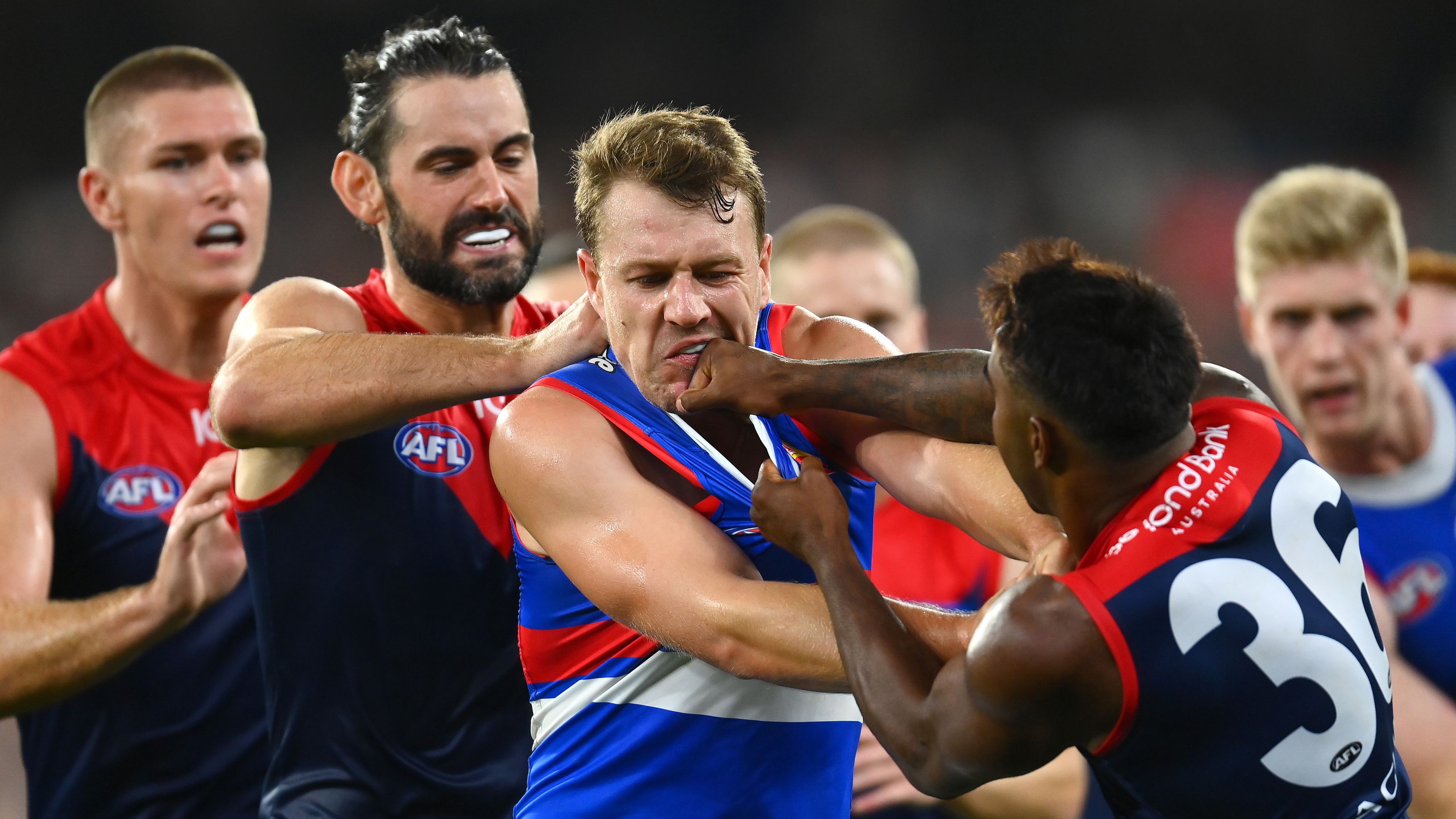 MELBOURNE, AUSTRALIA - MARCH 18: Jackson Macrae of the Bulldogs remonstrates with Kysaiah Pickett of the Demons after a bump on  Bailey Smith of the Bulldogs during the round one AFL match between Melbourne Demons and Western Bulldogs at Melbourne Cricket Ground, on March 18, 2023, in Melbourne, Australia. (Photo by Quinn Rooney/Getty Images)