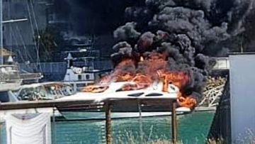 Firefighters are working to protect about half a dozen boats at Townsville&#x27;s Marina after a parked boat caught fire this afternoon. 