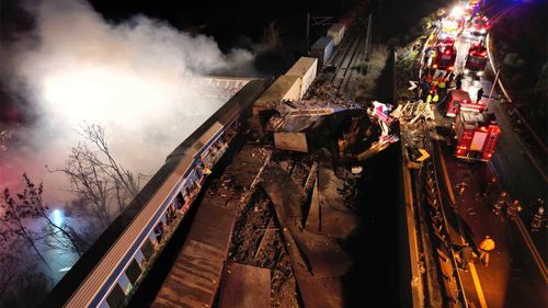 Smoke rises from trains as firefighters and rescuers operate after a collision near Larissa city, Greece.