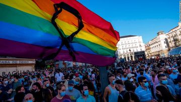 The rainbow flag with a black ribbon flutters during a protest against the killing of Samuel Luiz in the Puerta del Sol in central Madrid, Spain. 
