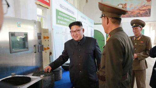 In this undated photo distributed Wednesday, Aug. 23, 2017, by the North Korean government, leader Kim Jong Un, left, visits the Chemical Material Institute of Academy of Defense Science at an undisclosed location in North Korea. (AAP)