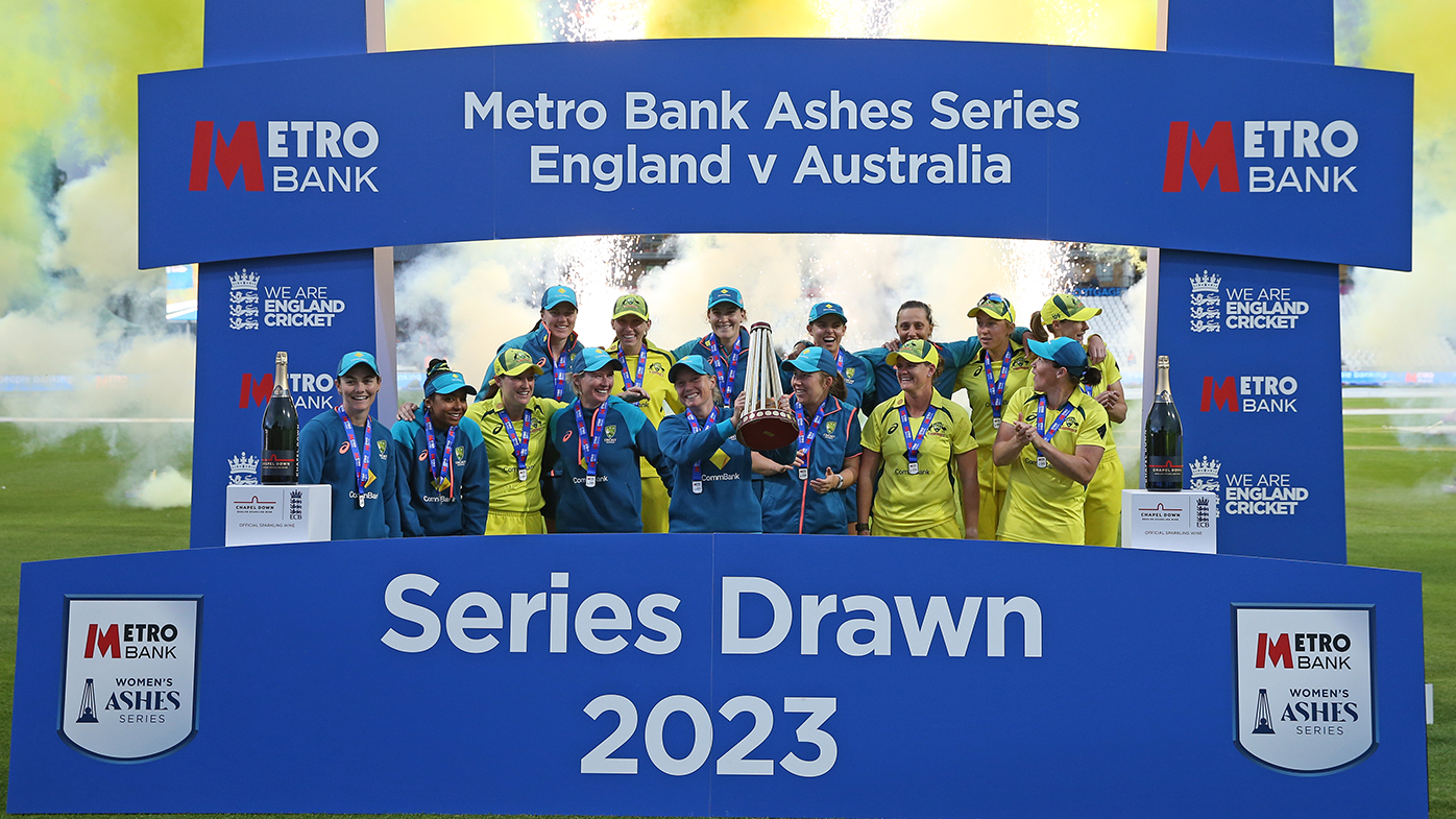 The Australian women&#x27;s cricket team celebrate with the trophy after retaining the Ashes after the third ODI match against England.