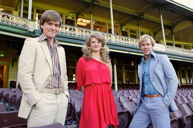 Actors appearing in the TV production titled "Howzat!" during the final days filming at the SCG. From left is Abe Forsythe (John Cornell), Cariba Heine (Delvene Delaney) and Travis Mcmahon (Paul Hogan) 23rd May 2012 Photograph by Dallas Kilponen