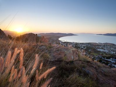 Sunset view of Townsville, Queensland, Australia looking from Castle Hill towards the coast and calm sea.