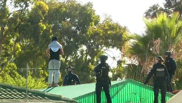 A man has been arrested after an hours-long standoff on a roof in Adelaide early this morning.