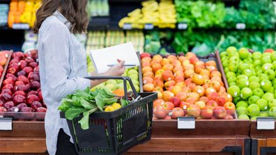 Woman grocery shopping stock generic 